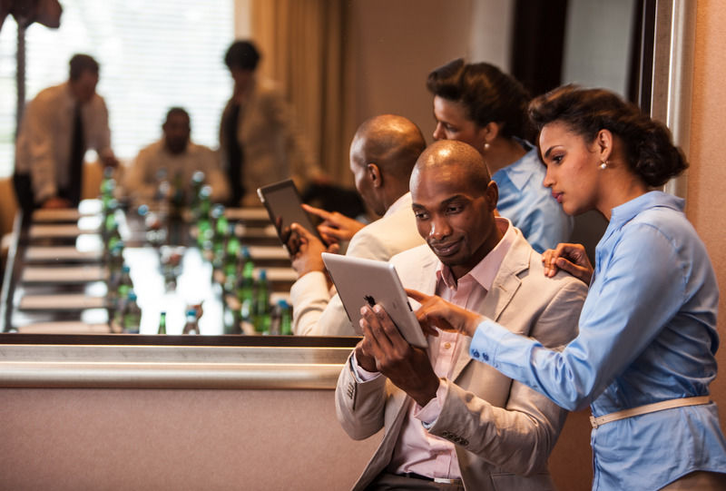 Suncoast Hotel & Towers Durban Esterno foto A man and a woman using a tablet computer